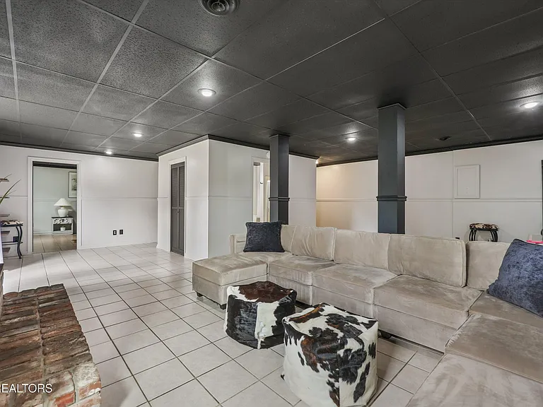 Finished basement recreation room with sectional seating at 11016 Calloway View Dr